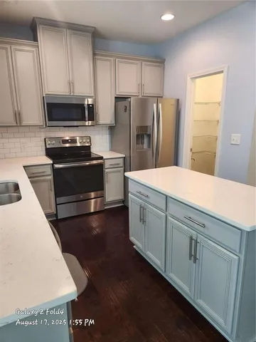 a kitchen with stainless steel appliances wooden cabinets and granite counter tops