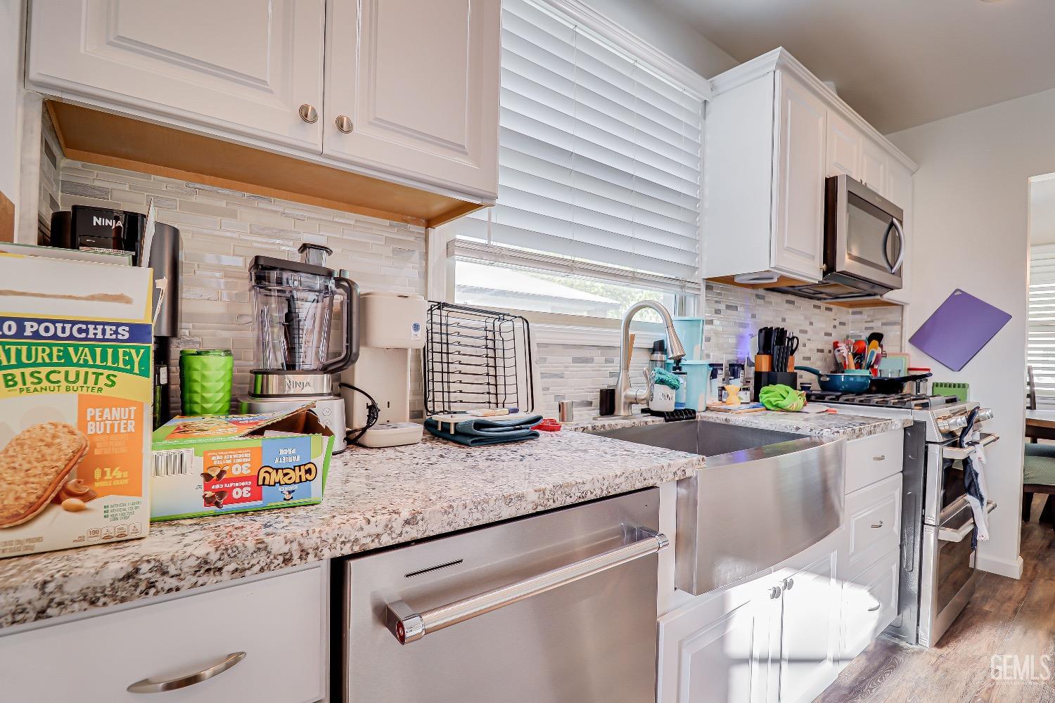 Undisclosed Address Bakersfield, CA 93304 - Photo 11 of 26 a kitchen with stainless steel appliances granite countertop a sink stove and cabinets