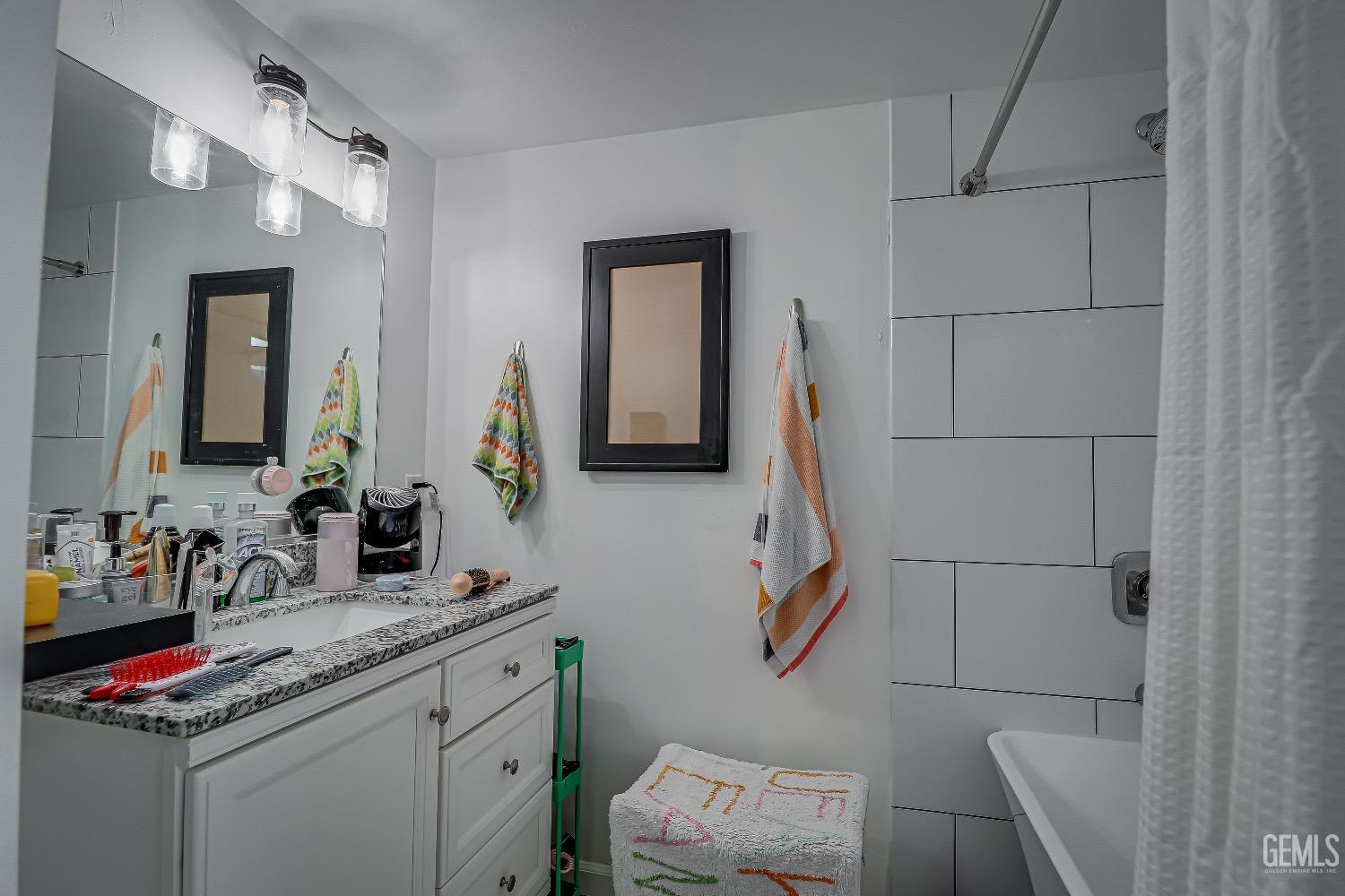 Undisclosed Address Bakersfield, CA 93304 - Photo 16 of 26 a bathroom with a granite countertop sink and a mirror