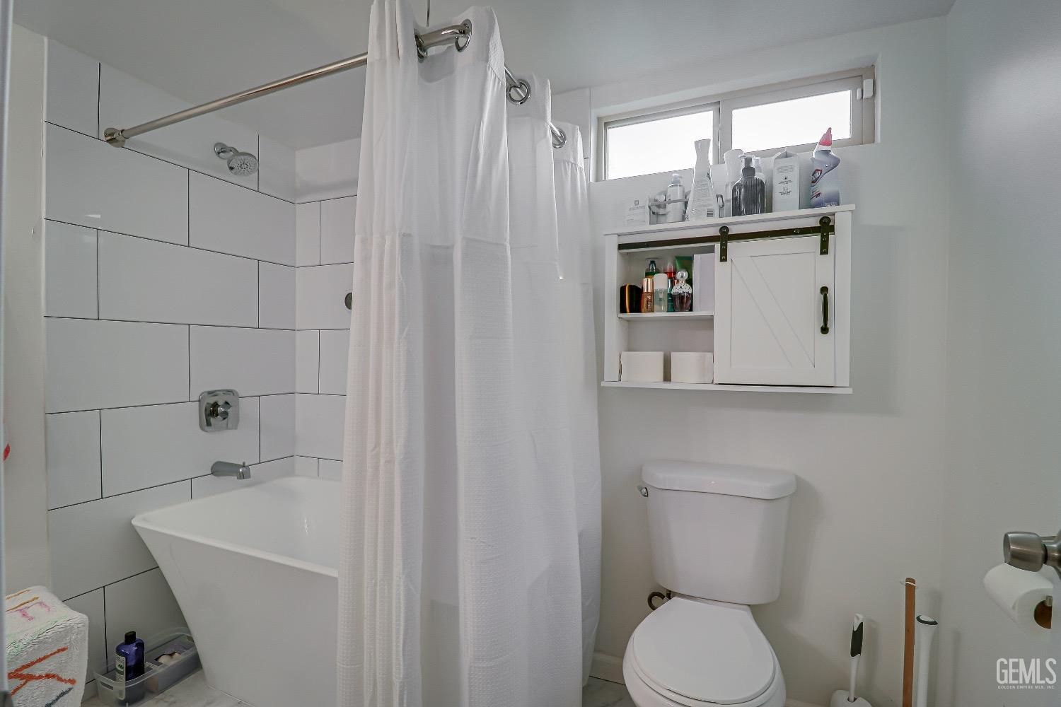 Undisclosed Address Bakersfield, CA 93304 - Photo 17 of 26 a bathroom with a sink a toilet and shower