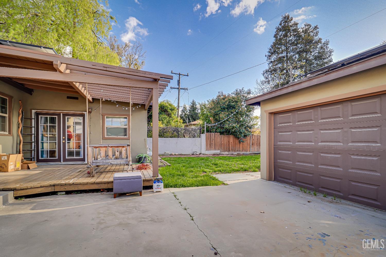 Undisclosed Address Bakersfield, CA 93304 - Photo 20 of 26 a view of a house with a large window and wooden fence