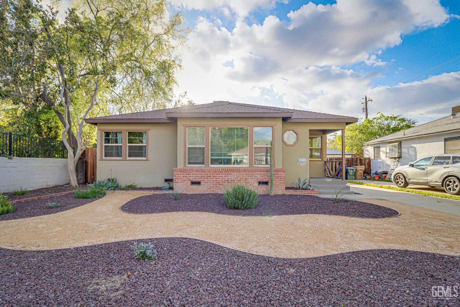 Undisclosed Address Bakersfield, CA 93304 - Photo 2 of 26 a front view of a house with garden and parking
