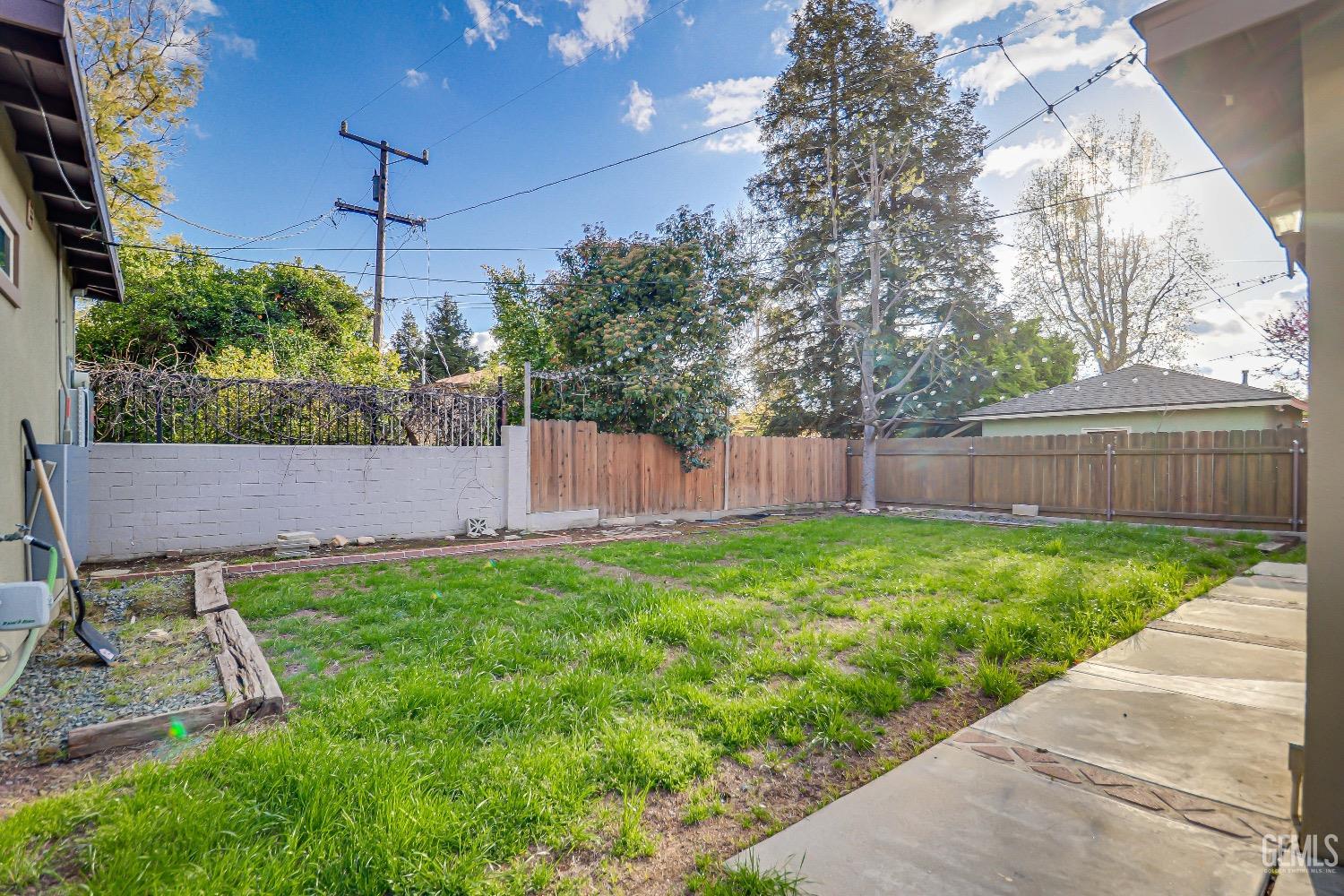 Undisclosed Address Bakersfield, CA 93304 - Photo 21 of 26 a view of a backyard with wooden fence