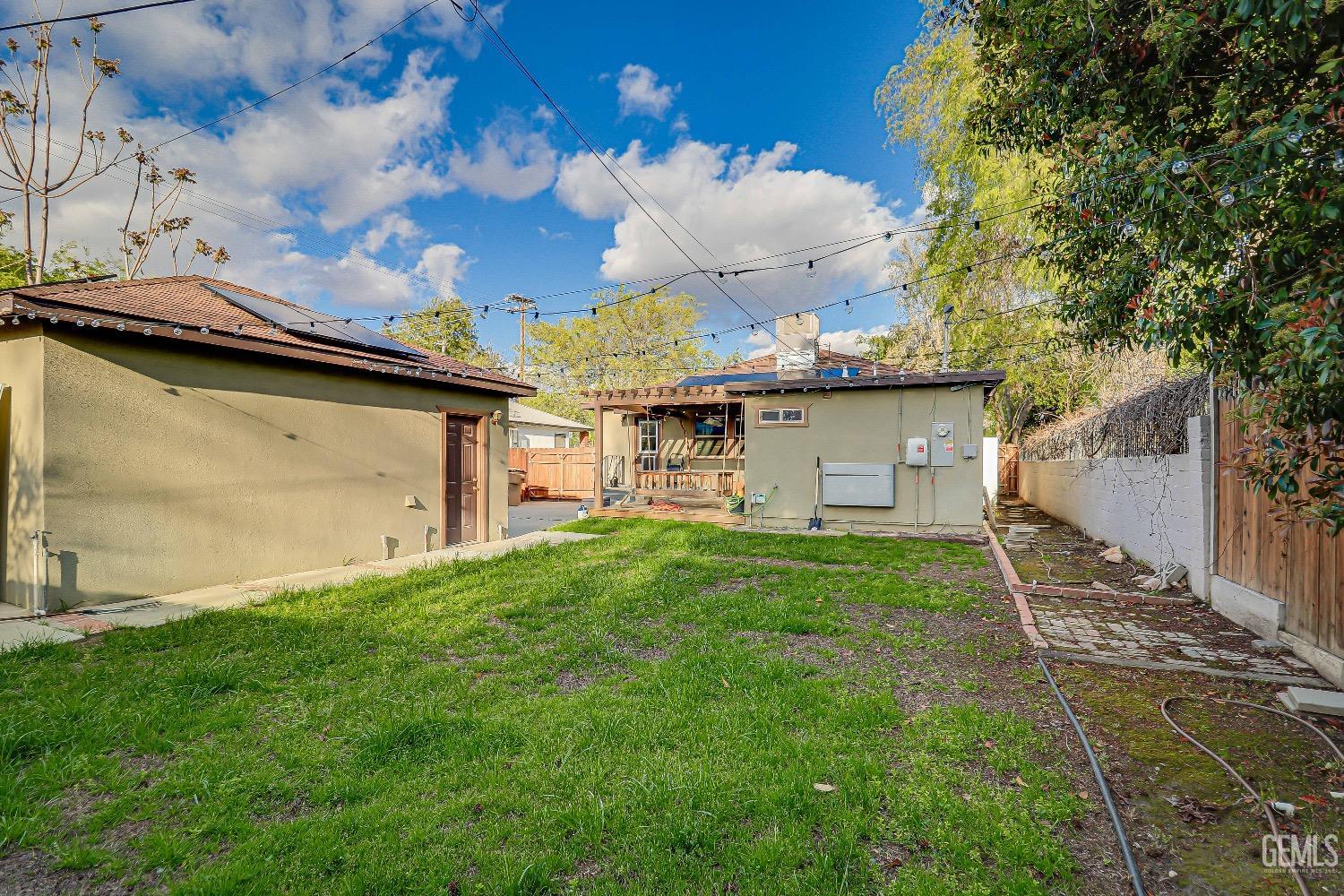Undisclosed Address Bakersfield, CA 93304 - Photo 23 of 26 a view of a backyard with plants and a large tree