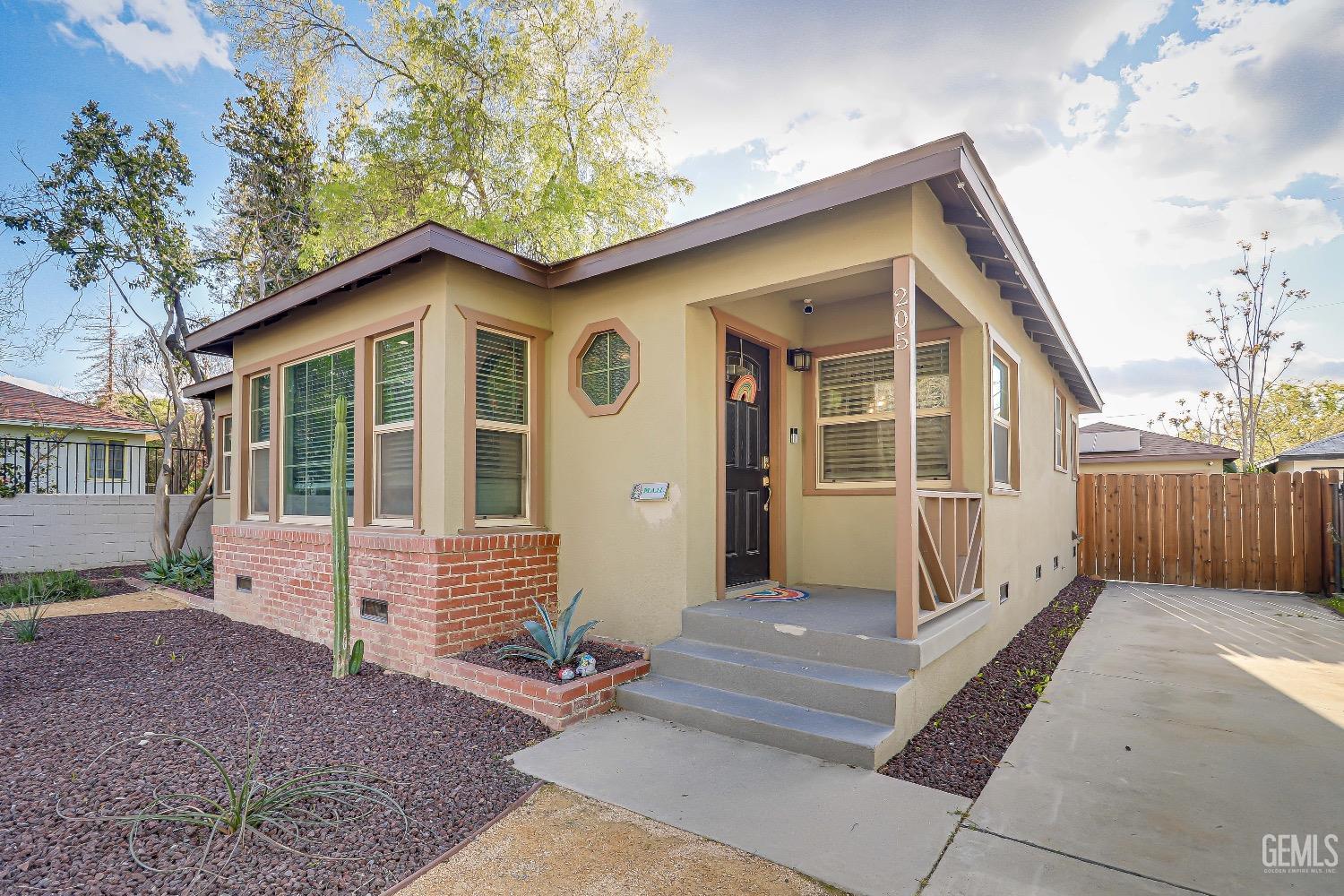 Undisclosed Address Bakersfield, CA 93304 - Photo 3 of 26 a front view of a house with a yard