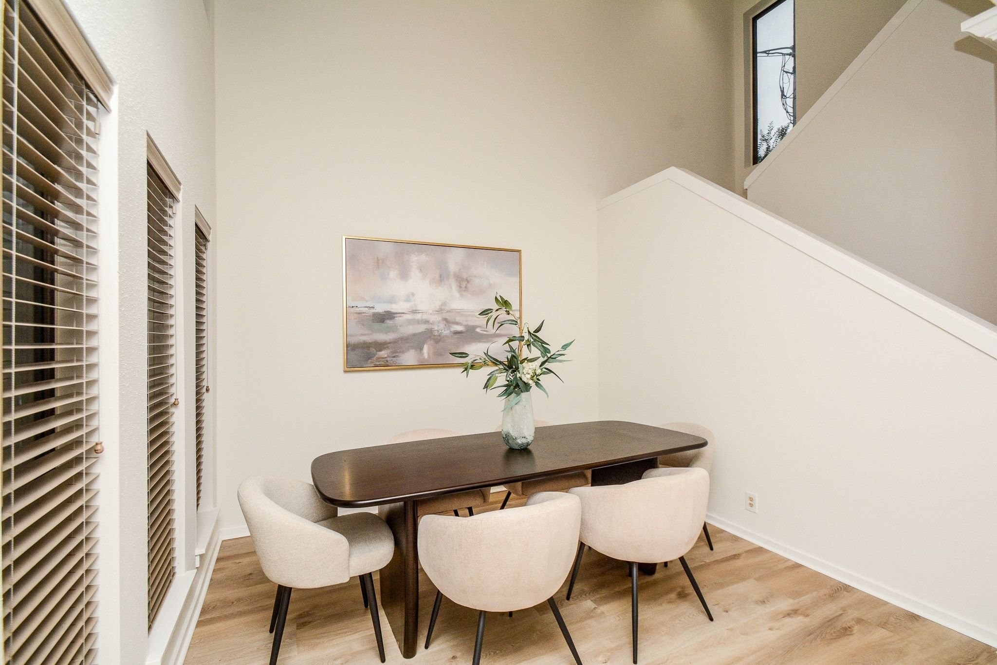 820 Harold Street Houston, TX 77006 - Photo 5 of 33 The dining area features soaring ceilings, wood-look floors, and a sun-filled bank of windows that make every meal feel a little more special.