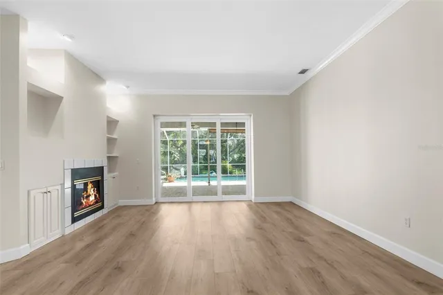 a dining room with furniture a rug a potted plant and a chandelier