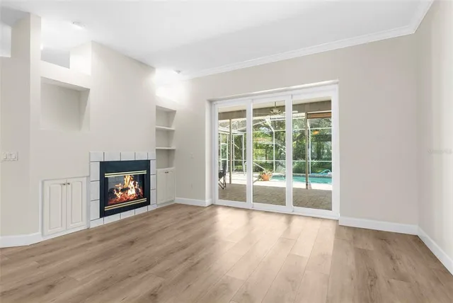a living room with furniture a flat screen tv and a large window