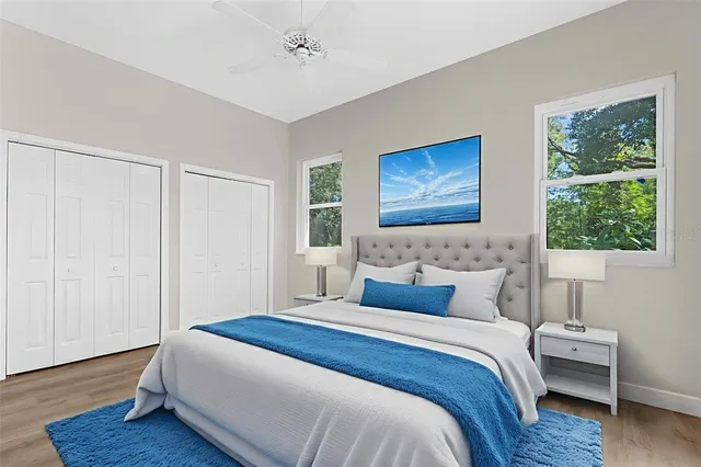 a view of a house with big yard and large trees