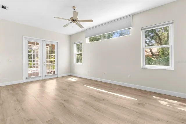 a spacious bathroom with a granite countertop sink a toilet and a mirror