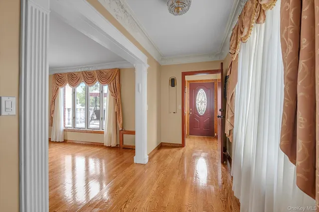 a view of hallway with livingroom and wooden floor