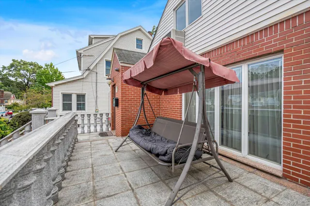 a balcony with table and chairs