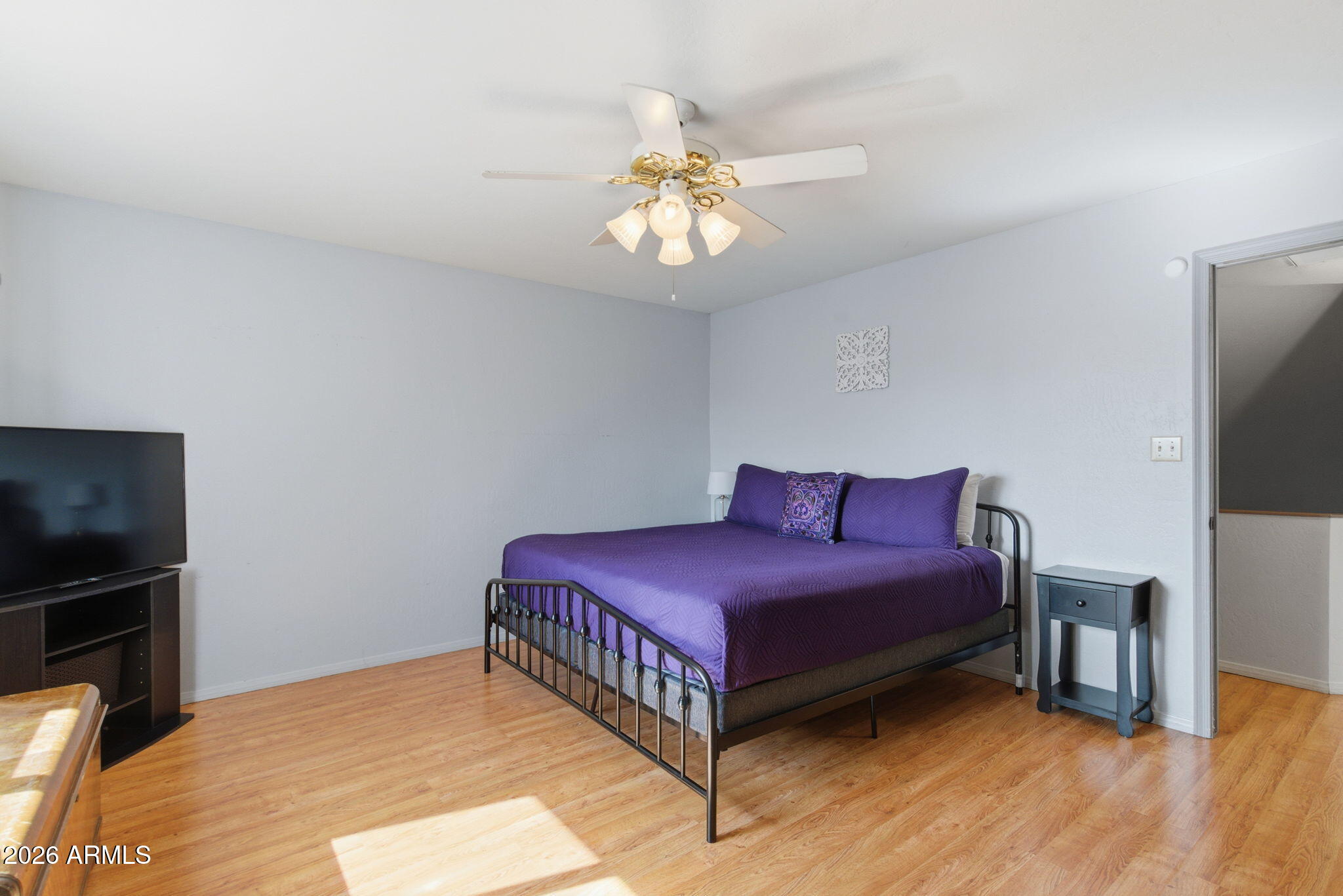 4218 West Boca Raton Road Phoenix, AZ 85053 - Photo 11 of 27 a bedroom with a bed and a flat screen tv