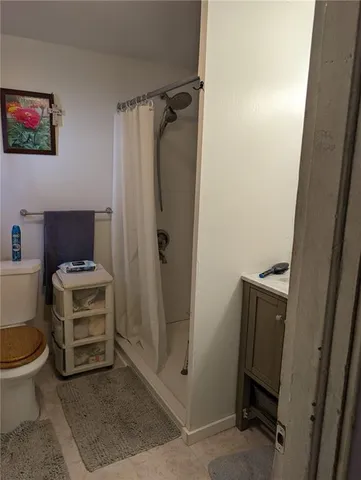a bathroom with a toilet and a shower