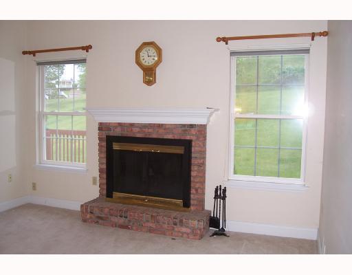 1110 Chapel Road Monaca, PA 15061 - Photo 3 of 7 Exterior Front. The Living Room Features a warm gas fireplace with attractive brick surround and wooden mantel. Two large windows look out over the backyard.