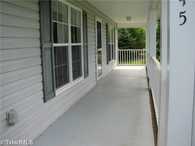 6045 Holder Road Clemmons, NC 27012 - Photo 3 of 16 Exterior Front. Rocking chair front porch.