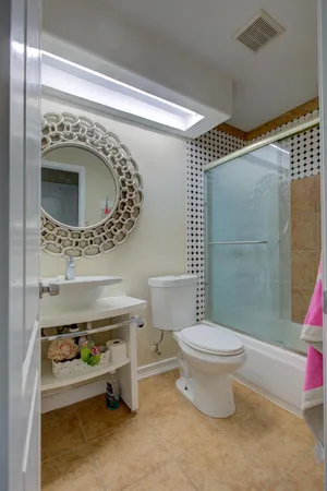 a bathroom with a toilet and a mirror