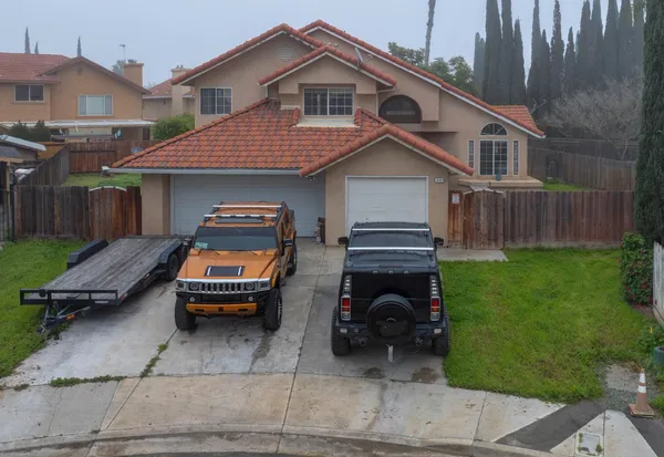 a view of a house with a small yard and sitting area