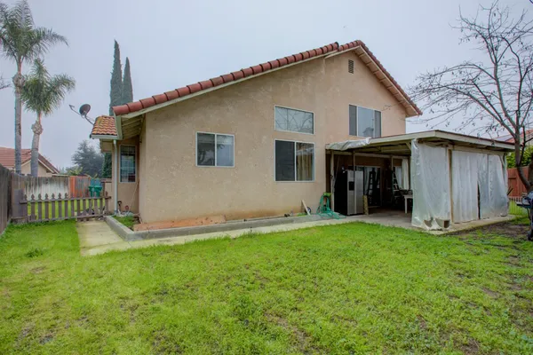 a view of an house with backyard space and garden