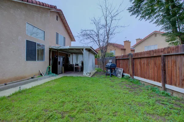 a view of a house with a yard and sitting area