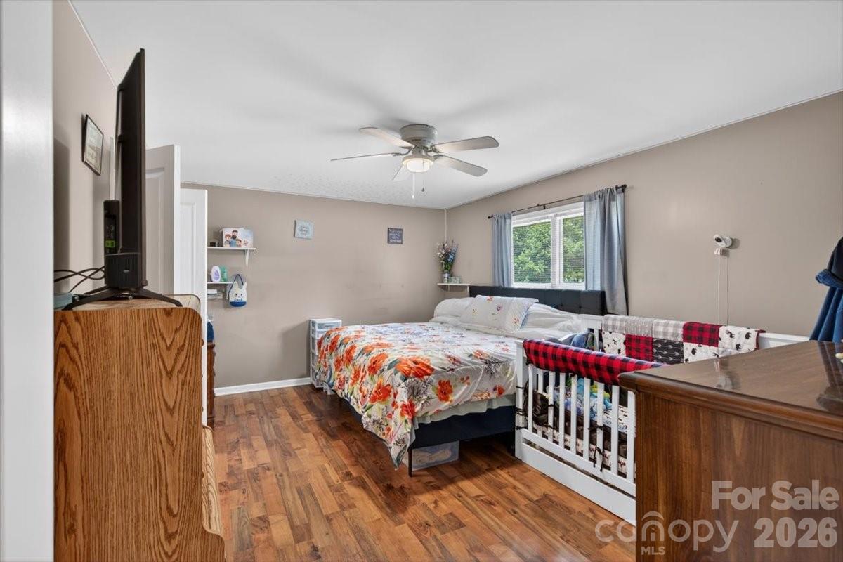 567 Godbey Road Mocksville, NC 27028 - Photo 16 of 38 a bedroom with a bed and a chandelier