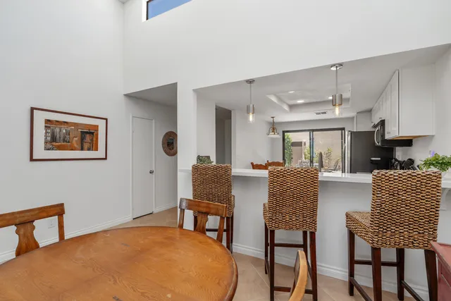 a view of a livingroom with furniture and a kitchen