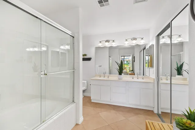 a large white kitchen with a large tub and sink