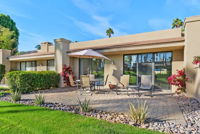a group of people sitting in front of a house