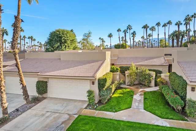 a aerial view of a house with a yard and potted plants