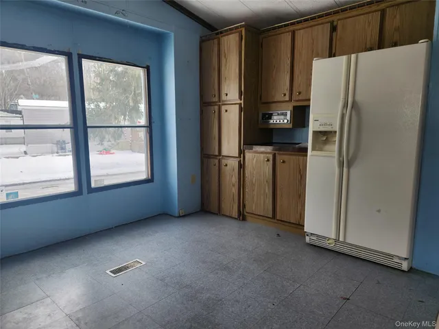 a view of kitchen with stainless steel appliances refrigerator and microwave