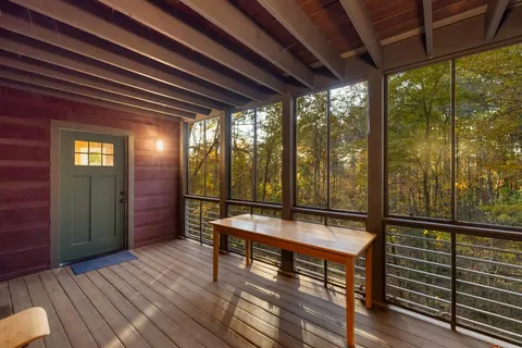 a spacious bedroom with a bed and wooden floor