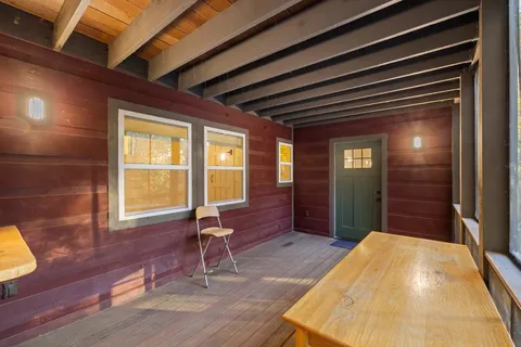 a backyard of a house with table and chairs