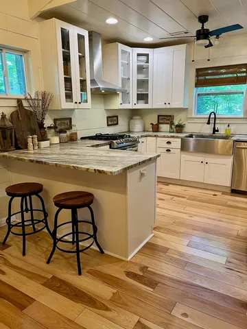 a bedroom with a bed and large mirror on the dresser