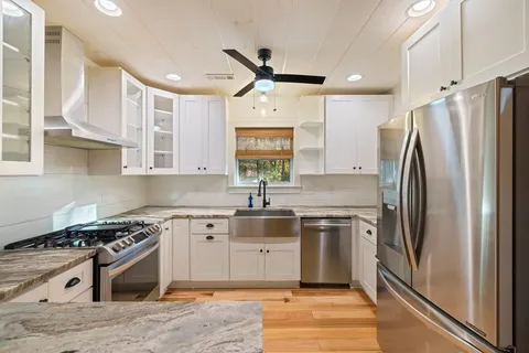 a kitchen with a stove a sink and a refrigerator