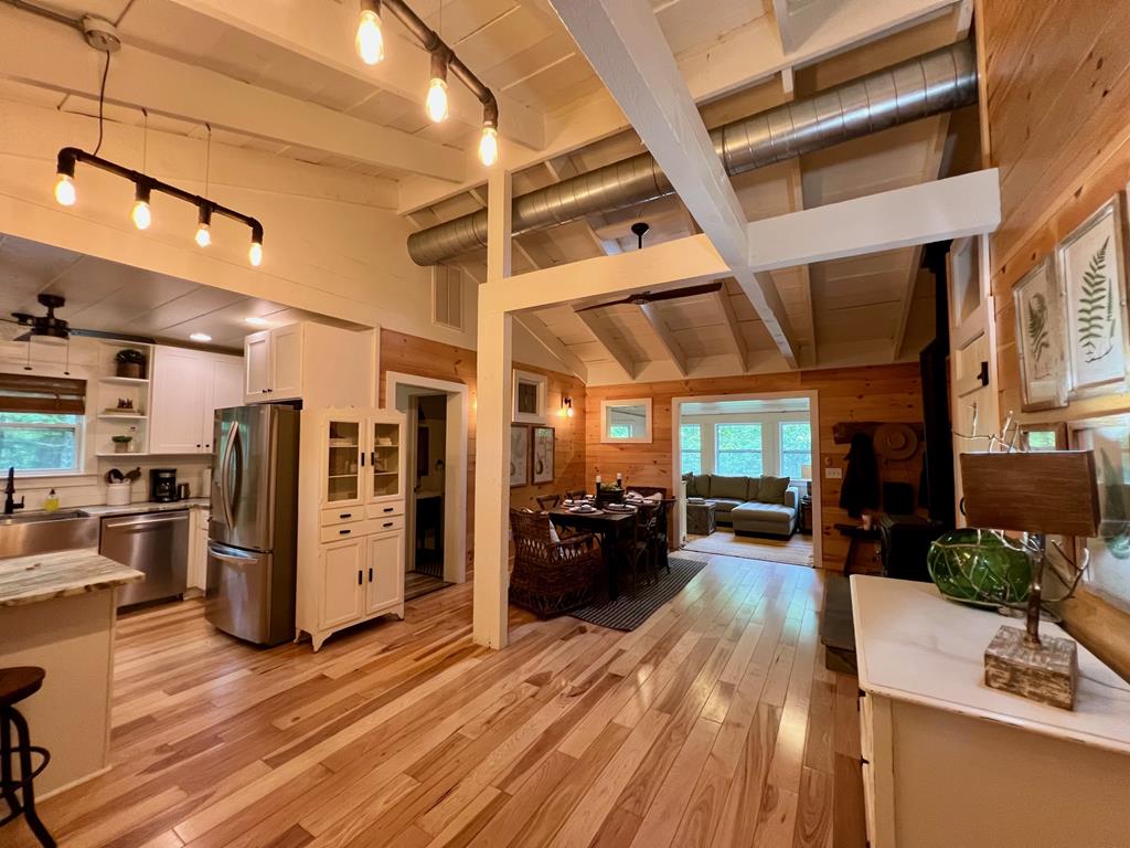 210 East Overbend Trail Blue Ridge, GA 30513 - Photo 61 of 69 a view of a living room with stainless steel appliances wooden floor and chandelier