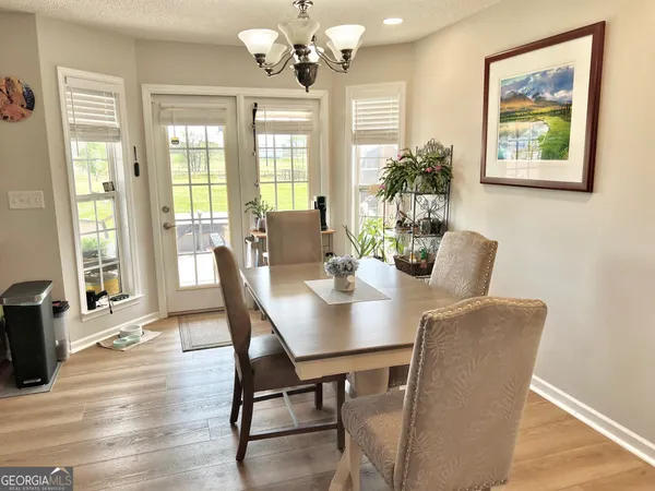 a view of a dining room with furniture wooden floor and chandelier