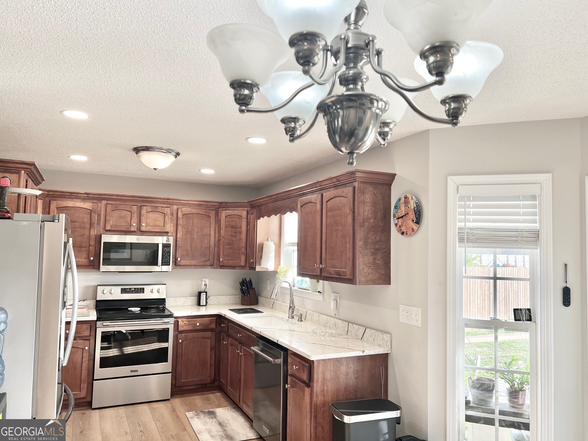 427 Chandler's Ridge Drive Chatsworth, GA 30705 - Photo 20 of 40 a kitchen with a sink stainless steel appliances and chandelier
