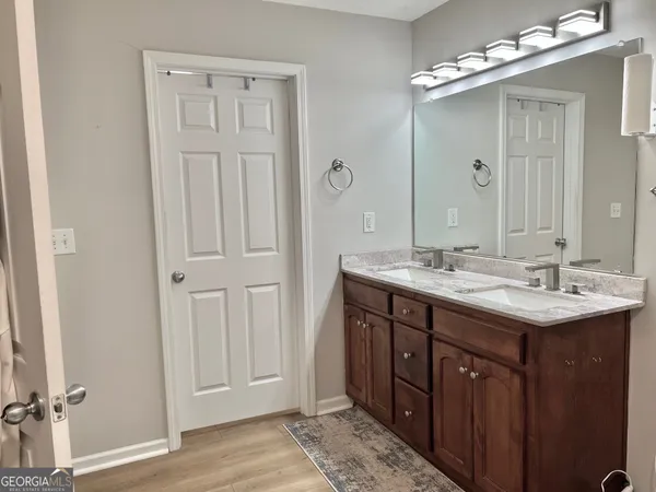 a bathroom with double sink and a mirror
