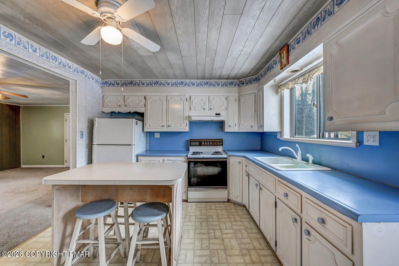 1912 Johns Road Effort, PA 18330 - Photo 12 of 44 a kitchen with stainless steel appliances granite countertop a sink a stove and a refrigerator