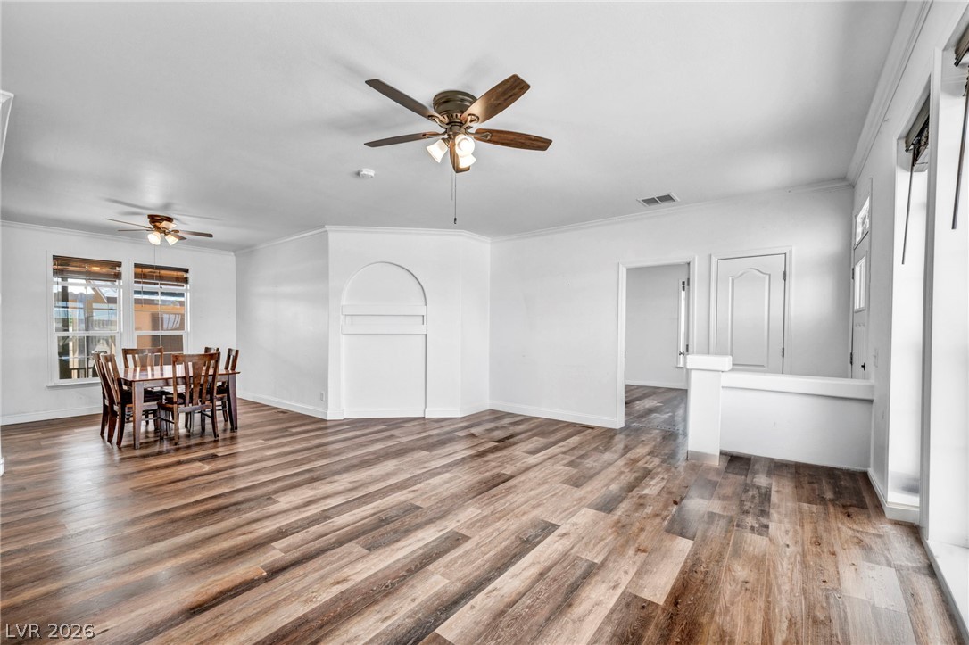 225 California Street Searchlight, NV 89046 - Photo 18 of 64 Hardwood-style flooring extends across an open-concept living area with a dedicated dining space.