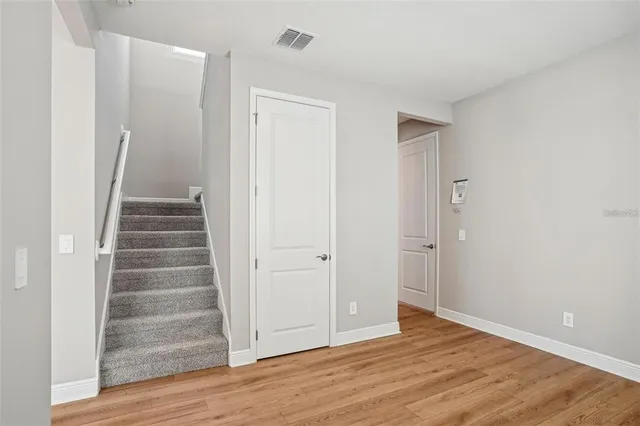 a view of an entryway with wooden floor