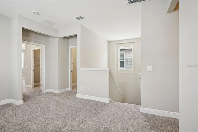 an empty room with windows and closet