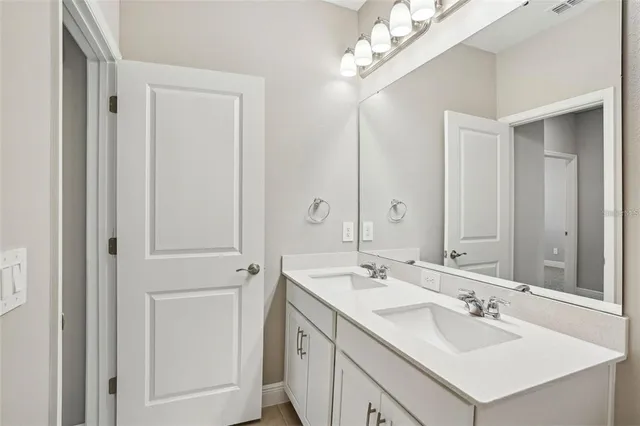 a bathroom with a sink vanity and a mirror