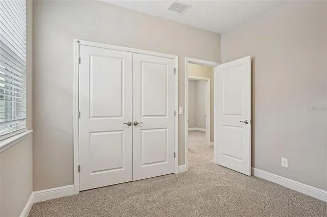 an empty room with closet area