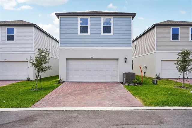 a front view of house with yard and green space