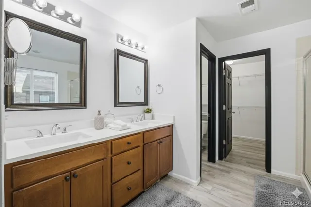 a bathroom with a double vanity sink and a mirror