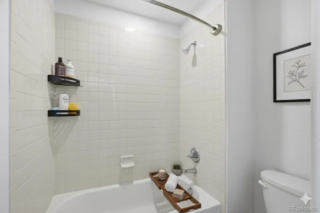 a bathroom with a shower and toilet