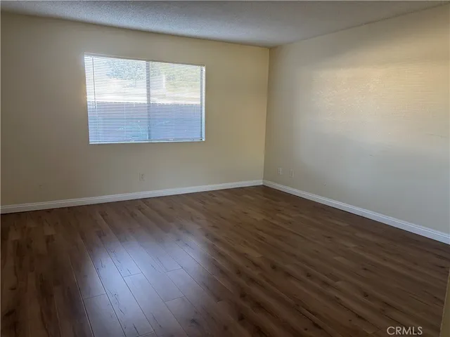 an empty room with wooden floor and closet