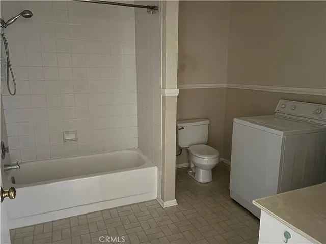 a patio with a table and chairs under an umbrella