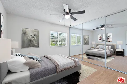 a bedroom with a bed and a couch